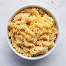 a white bowl full of pasta in it