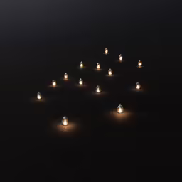 many small candles in the dark are lit