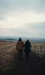 there are two people walking down the trail