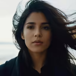 a woman that is standing with her hair in the air