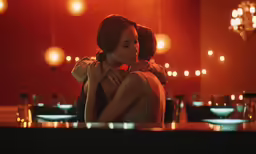 there is a woman standing in a dimly lit room