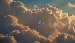some clouds that are in the sky with a white word below