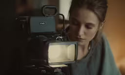 a woman is using a camera to take pictures