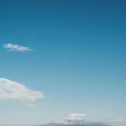 two people in a body of water on the beach
