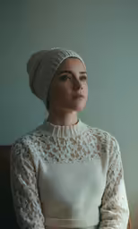 a woman wearing a head wrap sitting down
