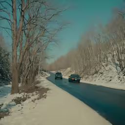 a picture of cars on a road in the snow