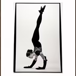 a woman doing a handstand in a black and white photo