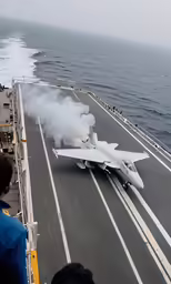 fighter jet on flight deck with smoke coming out from the ground