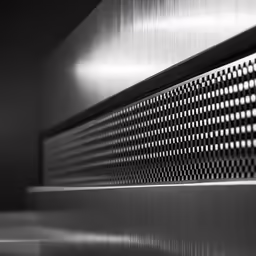 this wall has a large metallic grille on it