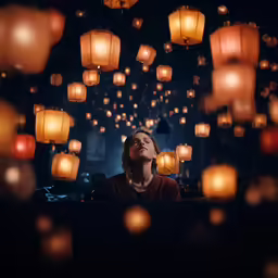 a woman standing in front of hundreds of lights