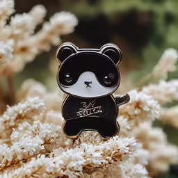 there is a bear brooche that says x - pelu