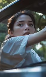 a woman in a white shirt holding her hand out of a window
