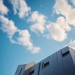 an apartment building is silhouetted against the blue sky