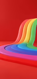 a pile of multicolored plastic on a red background