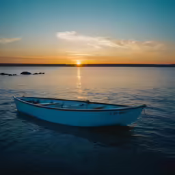 a small white boat sitting on top of a lake