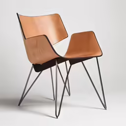 two chairs sit side by side against a gray background