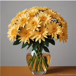 a vase filled with yellow flowers on top of a table