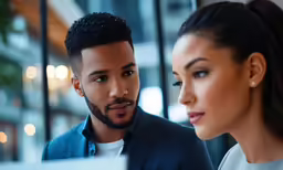 a man in a business suit looking at something on his screen
