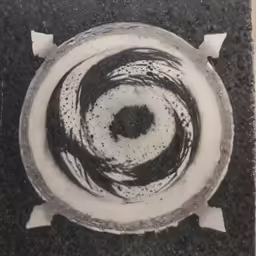 a small plate with several circular design in the middle