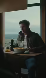 a man is eating food at the table
