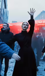 two women in black dresses on the street in the rain