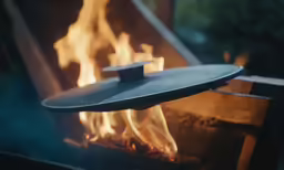 fire flames are lit with some round pan on the side