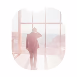 a man looking out of a window on a cold day