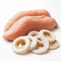 some pieces of raw food are next to a sausage