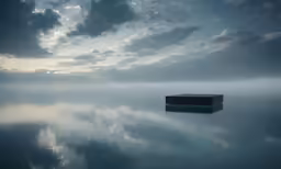 a cube in a body of water with a cloudy sky