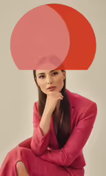 a woman wearing red, sitting down with her legs crossed