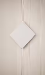 white square paper folded over wooden board