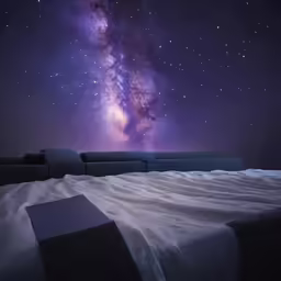 a bedroom scene with the milky rising above the stars