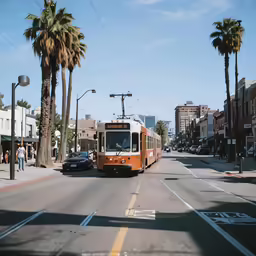 a small orange bus going down the street