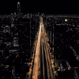 a dark city at night lit up with streetlights and cars