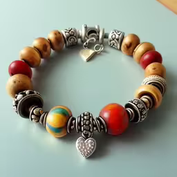 bracelet with multi - colored beads and charms on it,a bracelet with a heart and several beads
