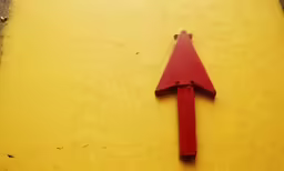 an arrow on a wall is painted bright red