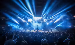 there are some people on a stage that has blue lights