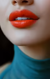 woman with red lipstick with black lashes and collar