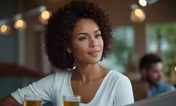 the woman is holding two glasses of beer