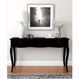 the photograph is hanging over the black table