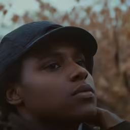 a young black boy wearing a hat