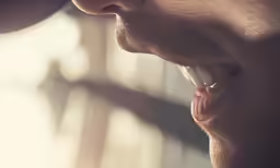 a man putting his lip full with his mouth open