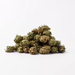 a pile of green cones sitting on top of a white table