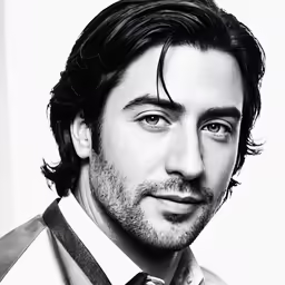 the man is looking at the camera while he wears a tie