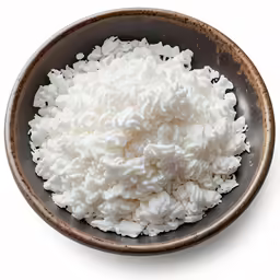 a bowl full of whipped milk that is on a white background