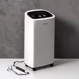 a very small white fan heater on a table
