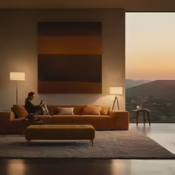a man is sitting in a living room reading a book