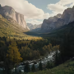 a valley in the mountains with a mountain stream running between it