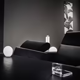 an empty office room with black chairs and glass table