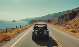 a green convertible is driving down the road